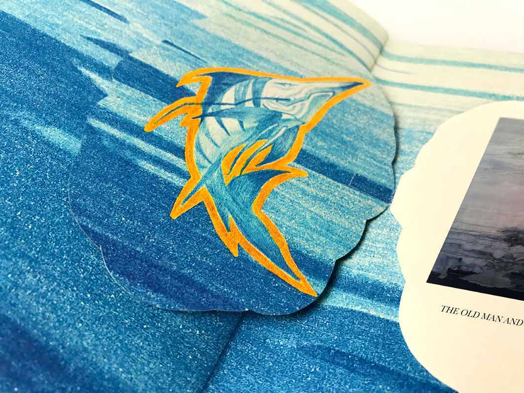 Layered paper marlin illustration on a blue ocean spread