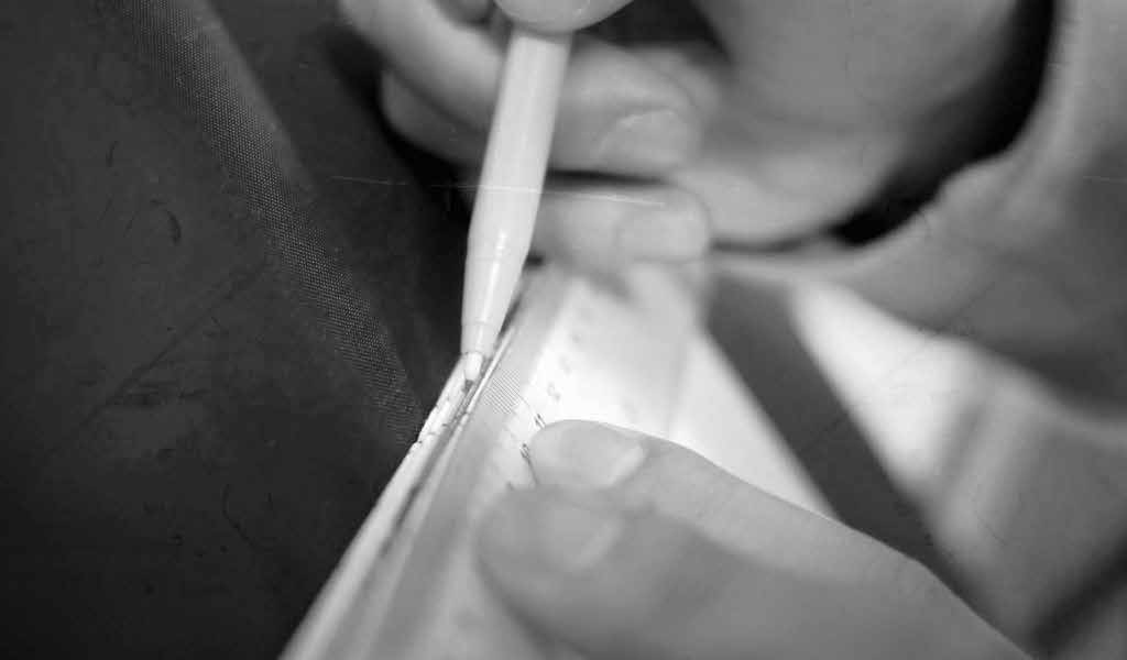 Hand piercing sewing holes along a folded spine