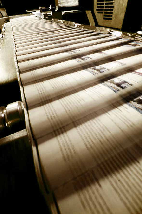 Printed sheets moving through an industrial printing press