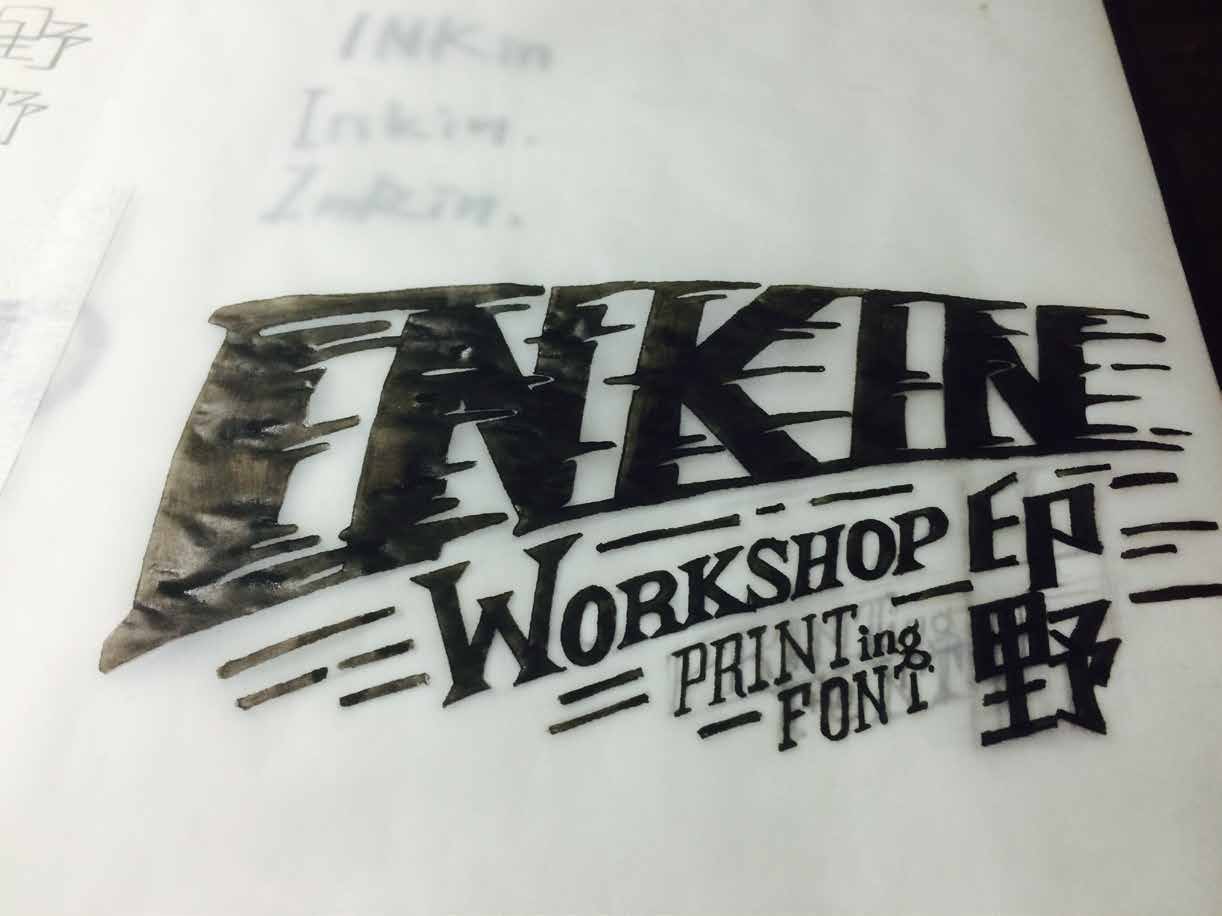 Hand-painted black INKIN wordmark study on tracing paper